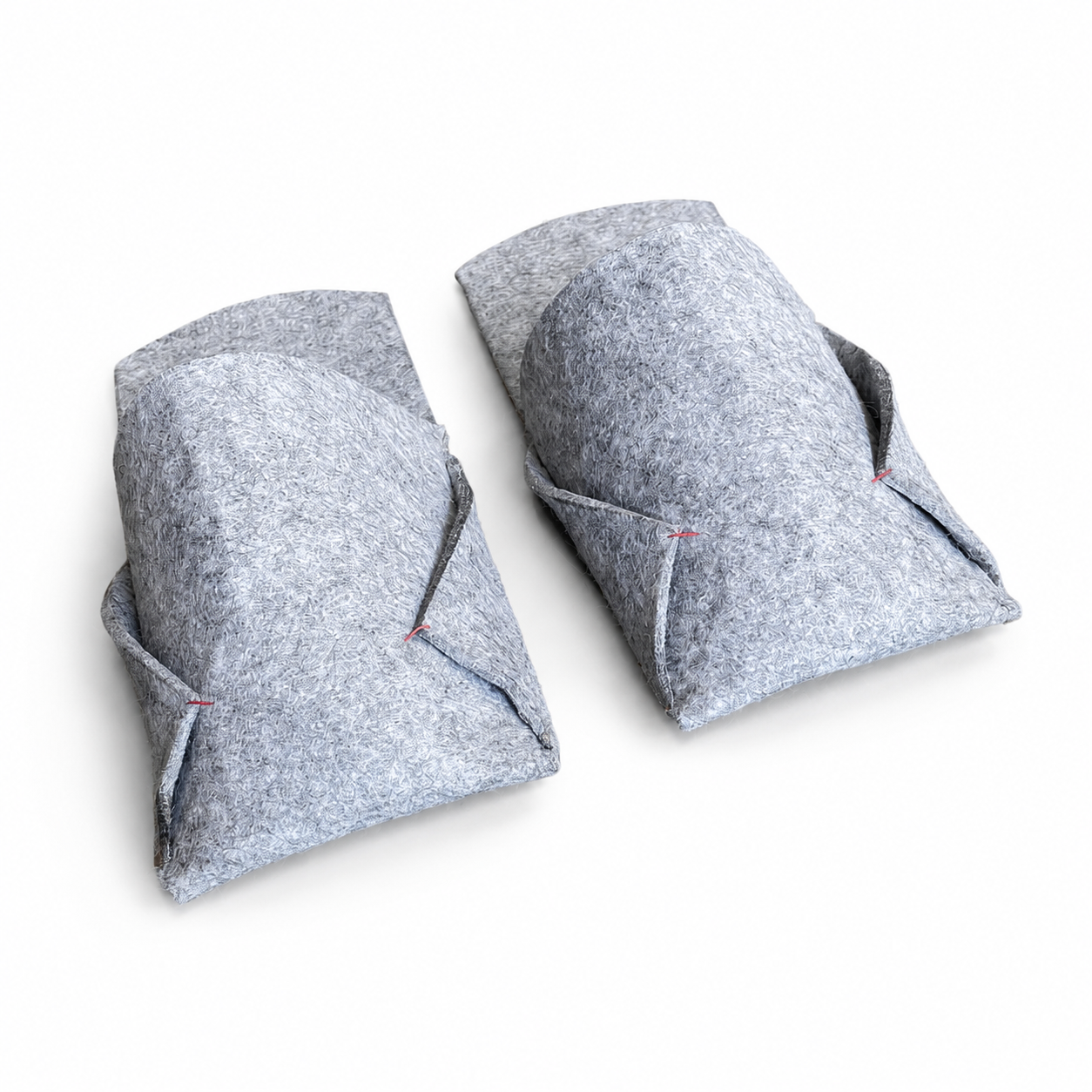 Side view of grey felted wool BAABUK slippers with structured wool upper and red stitching