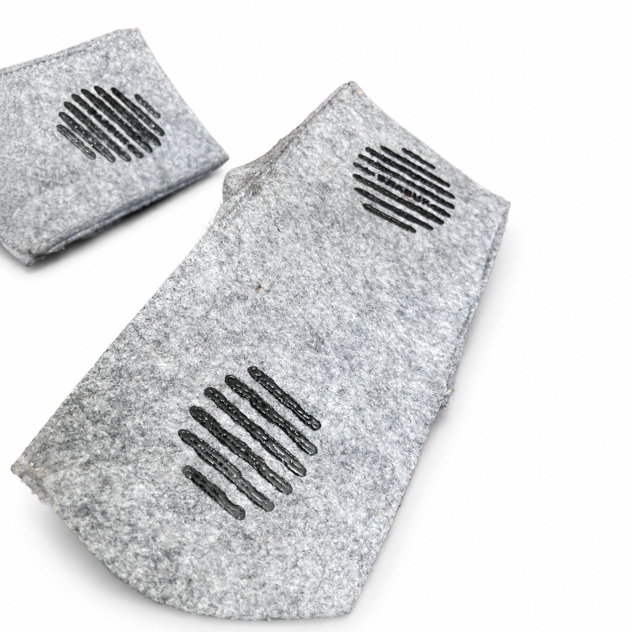 Sole view of grey felted wool BAABUK slippers showing the textured non-slip grip pattern